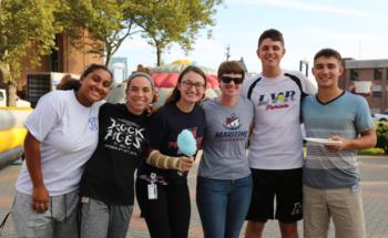 students smiling at an outdoor event