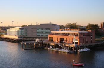 waterfront campus buildings at dusk