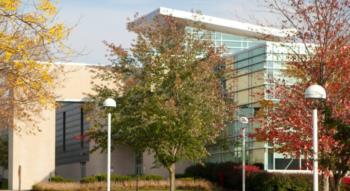 modern campus building with autumn trees