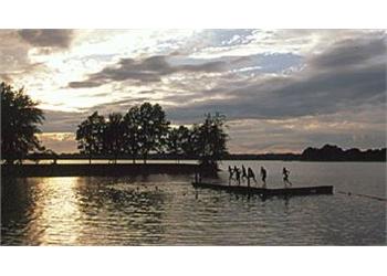 silhouettes on a dock at sunset