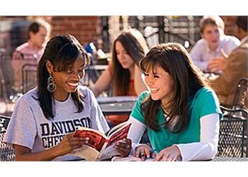 two students studying outdoors, davidson chiefs