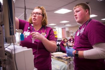 nursing students operating medical equipment