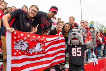 students holding gwu flag at homecoming