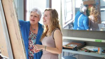student and teacher discussing art