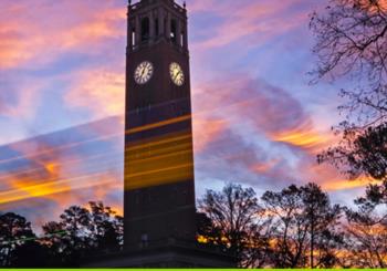 sunset behind a clock tower with ambient light streaks