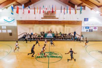 indoor basketball game with flags overhead