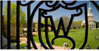 decorative iron gate with university initial &amp; campus view