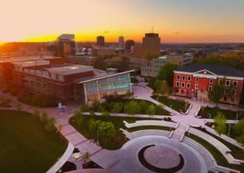 aerial view of university of akron with buildings and a circular plaza at sunset