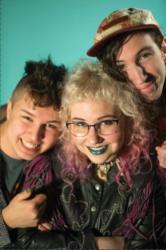 three smiling students with colorful hair and accessories