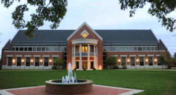 brick building with a triangular roof and large windows at defiance college