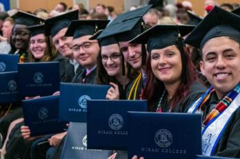 students holding diplomas at hiram college graduation ceremony