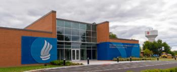 college building with logo and glass facade