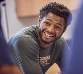 smiling student wearing john carroll university shirt