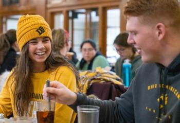 students socializing in a dining area wearing ohio dominican university apparel
