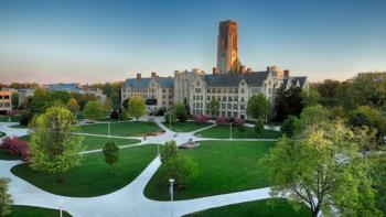 aerial view of university building surrounded by green lawns and walkways