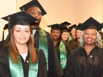 graduates in caps and gowns smiling