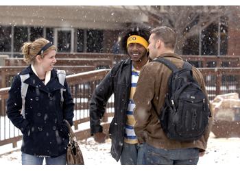three students talking on snowy day