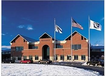 brick building with flags and snow on ground