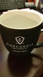 black coffee mug with 'concordia university' logo