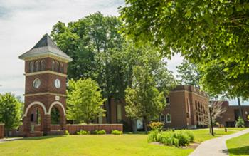 brick clock tower beside pathway