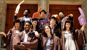 graduates smiling in caps and gowns