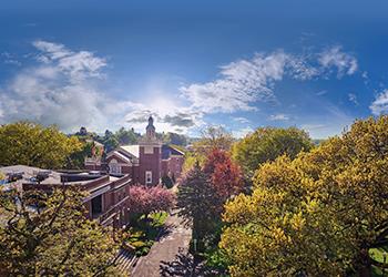 aerial view of campus buildings surrounded by autumn trees