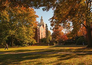 scenic view of a pathway with autumn foliage and campus building