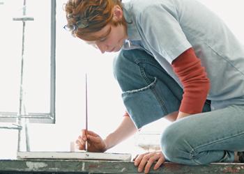 student painting by window