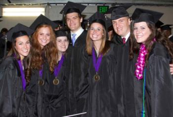 graduates smiling in caps and gowns