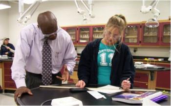 instructor and student discussing paper
