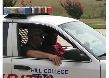 hill college security vehicle with two people inside
