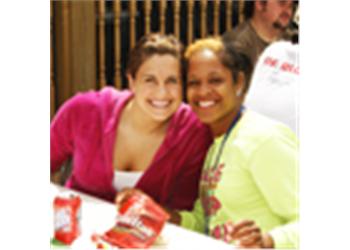 two smiling women sitting at a table