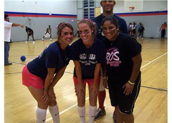 three people posing at a gym event