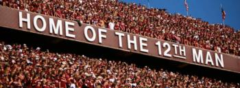 'home of the 12th man' sign with crowd
