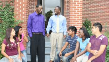 group of students chatting outside building