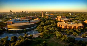 campus overview at dusk with city skyline