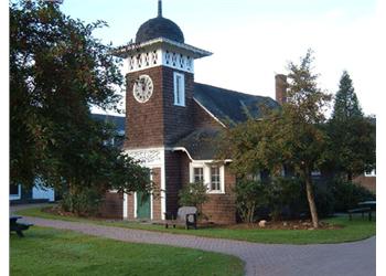 brick building with a clock tower surrounded by trees