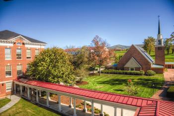 campus view with red brick buildings and church