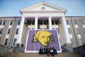 students in front of building with artwork