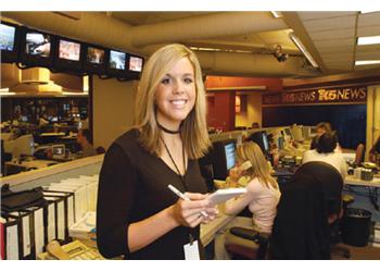 reporter with notepad in newsroom