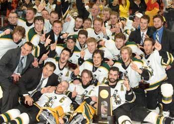 hockey team celebrating with a trophy