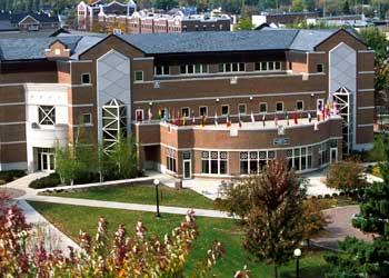 brick building with flags and a balcony