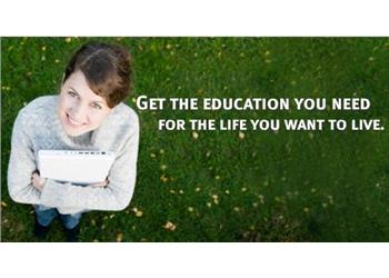person with laptop on grass with text 'get the education you need for the life you want to live.'