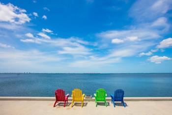 colorful chairs on waterfront overlooking bay