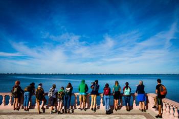 students facing water in a group activity