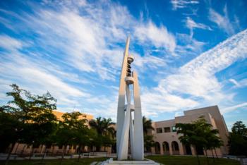 sunrise behind a tall campus monument