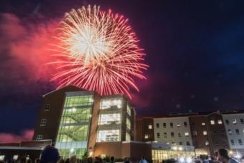 fireworks above campus building at night