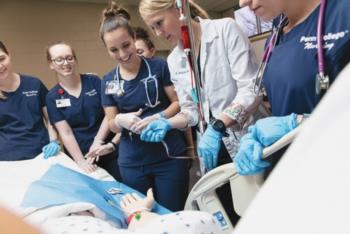nursing students practicing with manikin