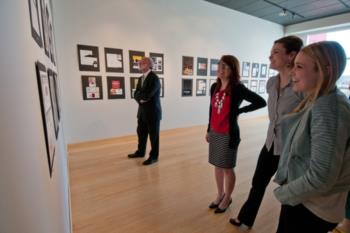 people viewing artwork on gallery walls