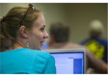 woman working on laptop in class
